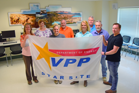 Employees at Hanford’s Waste Treatment and Immobilization Plant display a flag recognizing the plant as a DOE Voluntary Protection Program Star status site. 