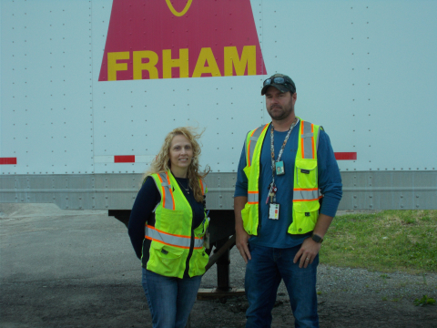 Renea Call, CH2M HILL BWXT West Valley (CHBWV) warehouse manager, and Cole Green, CHBWV demolition readiness manager, stand in front of the West Valley Demonstration Project Site’s personal protective equipment trailer.