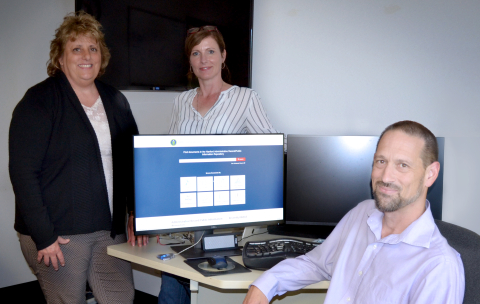 Ben Ellison, Hanford Site chief information officer, far right, Suzanne Johnson, Mission Support Alliance (MSA) project manager, far left, and Carolyn Noonan, MSA environmental integration services, demonstrate the updated Hanford Administrative Record.