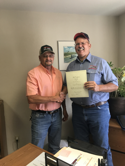 Randahl Mills, CAST Specialty Transportation Carlsbad terminal manager, left, presents Mark Beene with an award for 20 years of service with CAST and EM's Waste Isolation Pilot Plant. 
