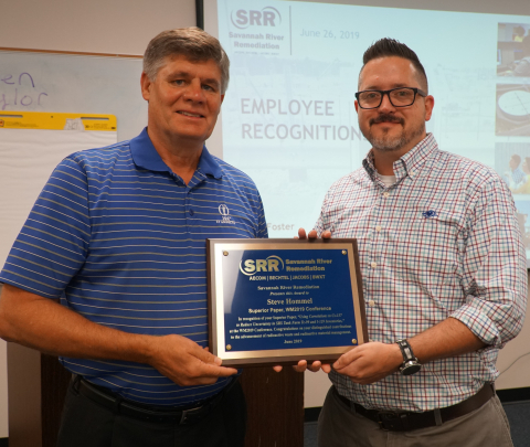 Savannah River Remediation (SRR) President and Project Manager Tom Foster, left, presents SRR Principal Engineer Steve Hommel a plaque in honor of his 2019 Waste Management Symposia Superior Paper Award.