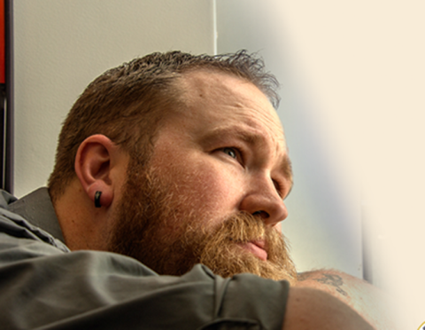 veteran staring outside of a window 