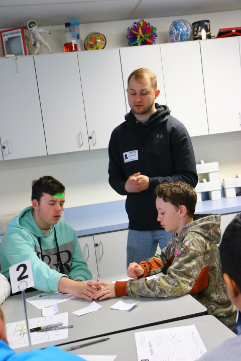 Yuriy Dubinets, a mechanical engineer with EM Richland Operations Office contractor Mission Support Alliance, demonstrates to local middle school students how a Stirling engine uses heat to operate.