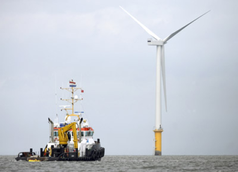 A boat sails near the Siemens' 3.6 MW Offshore Wind Turbine
