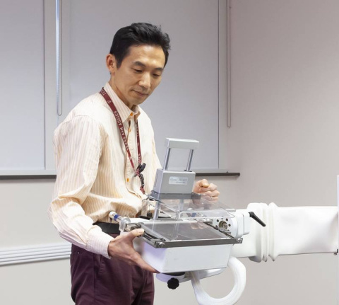 Seung Joon Lee holds the variable angle slant hole collimator. This device can help a breast molecular imaging system get six times better contrast of cancer lesions, providing the same or better image quality while potentially halving the radiation dose.