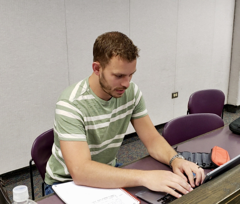 Daniel Walker works on an assignment at Idaho State University. While a Fluor Idaho intern, Walker responded to the information technology needs of computer users and even developed an app.