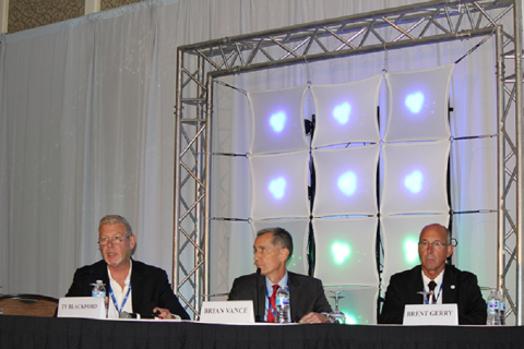 Hanford Site Manager Brian Vance, center, is joined by Ty Blackford, president of CH2M Hill Plateau Remediation Company, far left, and Brent Gerry, mayor of the City of West Richland, Washington, as he leads a panel discussion on Hanford cleanup activitie