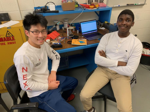 Building a levitator: Alex Ni, left, and Remy Plattiers, with the levitator beside the computer behind them. Building a levitator: Alex Ni, left, and Remy Plattiers, with the levitator beside the computer behind them.
