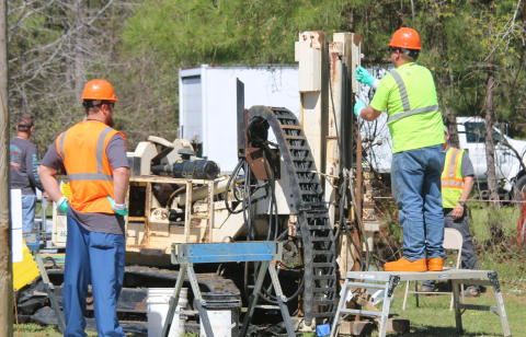 Ian Reed, left, a Savannah River Nuclear Solutions (SRNS) radiation control inspector, observes Josh Justice, a driller for SRNS subcontractor Cascade Drilling, during the installation of an injection well for the silver chloride cleanup strategy at the S