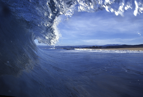 A photo of a wave breaking in the ocean. 