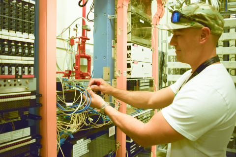 Technician Quinn Bragg with EM Richland Operations Office contractor Mission Support Alliance installs new equipment as a part of a project to upgrade phone service at the Waste Treatment and Immobilization Plant. The work supports a program to treat Hanf