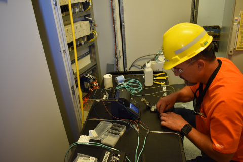Electrician Nathan Klebaum installs fiber optic cables inside an electrical powerhouse for the Effluent Management Facility at EM Hanford’s Waste Treatment and Immobilization Plant.