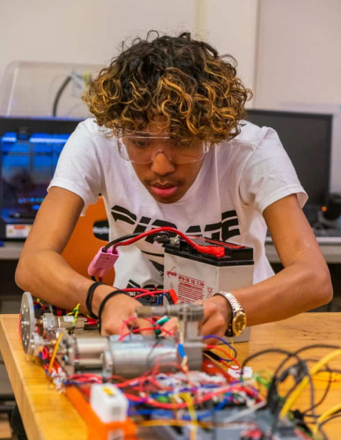 a photo of a student working on an electrical project.