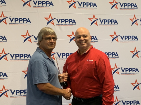 Billy Ellington, left, receives the 2019 Safety and Health Outreach Award from J.A. Rodriguez, chair of the DOE Voluntary Protection Programs Participants’ Association National Board of Directors. 