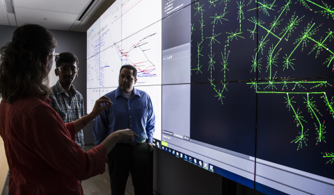 Cybersecurity image, three people chatting