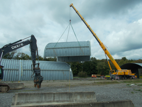 A large crane is used to relocate sections of a former waste storage structure for safe demolition at EM’s West Valley Demonstration Project Site.