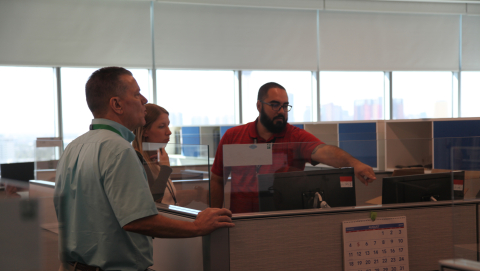 From left, Ray Mele, Kelly Pavelka, and David Mendez, all employees with EM Nevada Program contractor Navarro, discuss the logistics of the program's relocation to new offices in Las Vegas.