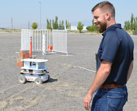 Washington River Protection Solutions (WRPS) scientist Alex Pappas watches a remote-controlled robot crawler during a recent test run. The mobile crawler can maneuver around objects and be fitted with a wide range of equipment.