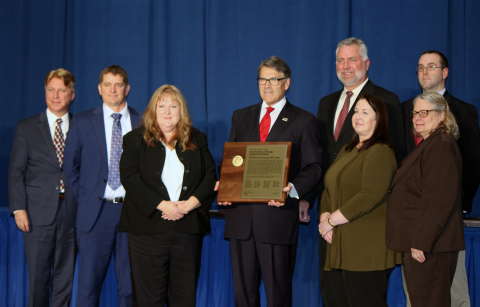 Some of the members of the End State Contracting Team accept the Secretary of Energy Achievement Award from Secretary Rick Perry on behalf of the 27-member team. From left are Bryan Foley, Benjamin Lindholm, and Janis Ward, Hanford Site; Secretary Perry; 