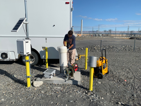 Juan Aguilar with Hanford contractor CH2M HILL Plateau Remediation Company prepares to take a groundwater sample from a well at a soil treatability test site in Hanford’s 100 K Area. 