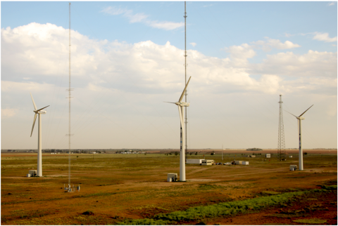 wind turbines against a blue sky.