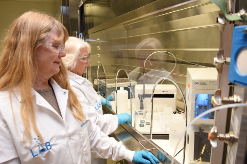 Inorganic Chemistry Supervisor Katherine Keltner, left, and Laboratory Training Specialist Stephanie Servi work with scientific instruments inside the Analytical Laboratory at Hanford’s Waste Treatment and Immobilization Plant.
