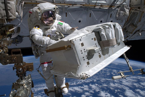 Astronaut repairing cosmic ray tool