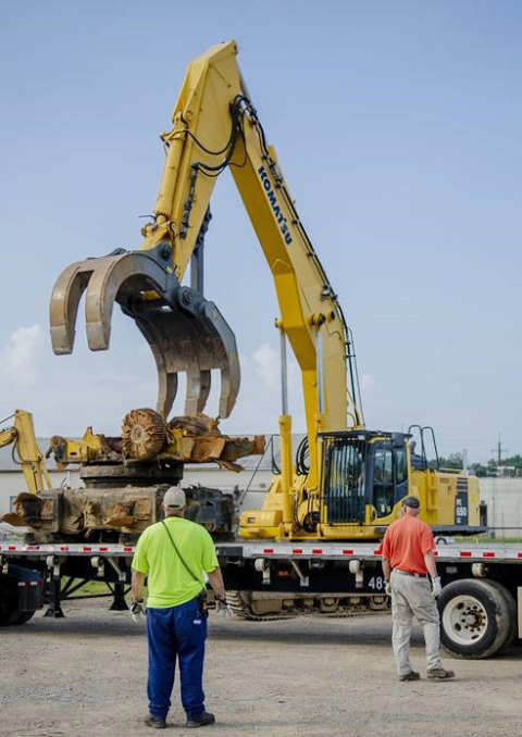 Four Rivers Nuclear Partnership workers load debris from the recent cleanout of the C-740 Material Yard, one of the site’s largest storage yards. 