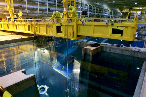 EM workers at the Idaho Nuclear Technology and Engineering Center transfer Experimental Breeder Reactor-II spent nuclear fuel from the Chemical Processing Plant-666 basin to a shipping cask.