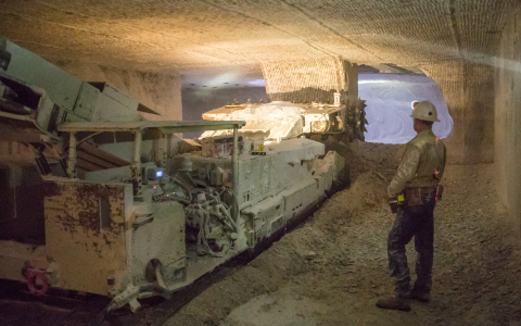 EM crews prepare the next area where transuranic waste will be emplaced at EM's Waste Isolation Pilot Plant. A continuous miner, at left, cuts through salt 2,150 feet beneath the surface.