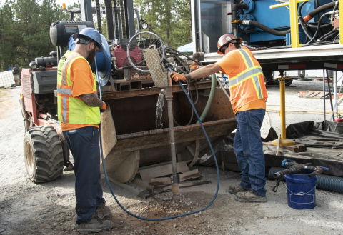 Injecting material containing iron filings into wells at the Savannah River Site is a multi-step process. A well is flushed with water, shown here, before workers add the iron filings to it.