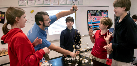 Savannah River Nuclear Solutions Engineer Graham Jones measures the height of a tower built using only marshmallows and uncooked noodles during a Savannah River Site teach-in at the Episcopal Day School in Augusta, Georgia.