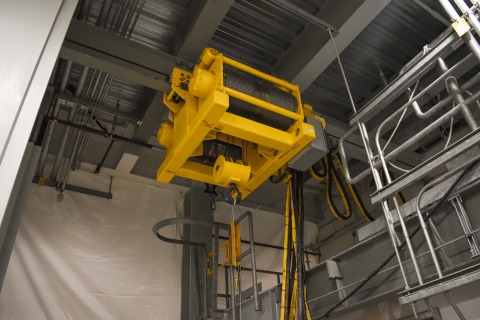 A 10-ton transfer hoist, located in the Hanford Site’s Low-Activity Waste Facility, is a key component in moving containers filled with treated tank waste. During operations, the remotely operated hoist will function behind a shield door.