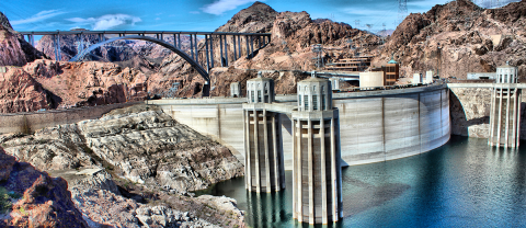Water and Hoover dam against the mountains.