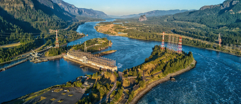 View of a hydropower facility and river at sunset.