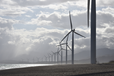 Wind turbines along a shoreline.