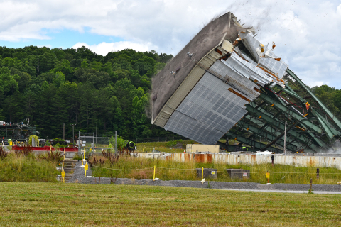 Crews use large winches to tear down a 180-foot tower of the Centrifuge Complex at Oak Ridge.