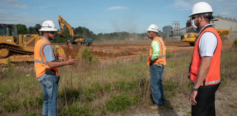 While maintaining social distancing, Savannah River Nuclear Solutions (SRNS) heavy equipment operators Tyler Wilson, left, and Ed Townsley, center, update SRNS Project Manager Kelsey Holcomb regarding the D-Area Coal Storage Yard Project at the Savannah R