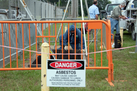 Savannah River Nuclear Solutions mechanic Curtis Williford helps remove the cover of an industrial wastewater tank within a containment pit at the Savannah River Site. 