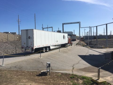 A truck containing a small amount of Defense Waste Processing Facility recycle wastewater departs a loading area at the Savannah River Site.