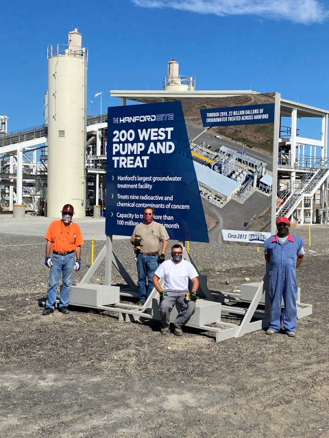From left, Hanford Site carpenters Carl McLaughlin, Rick Russert, Mike Finney, and Doug MacDonald pause for a photo after installing one of 15 landmark signs commemorating cleanup projects across the 580-square-mile site that produced approximately two-th