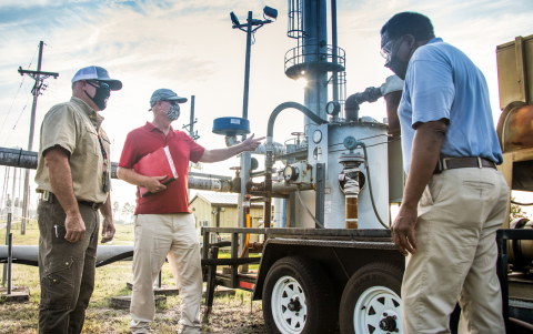 From left, Savannah River Nuclear Solutions mechanic Todd Cockrell, engineer John Bradley, and project manager Joao Cardoso-Neto plan the removal and dismantlement of a high-vacuum soil vapor extraction unit at the Savannah River Site.