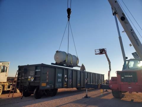 Workers at the Paducah Site load depleted uranium oxide cylinders onto a specialized railcar for shipment to the Waste Control Specialists Federal Waste Facility.