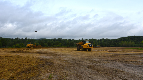 An EM worker relies on a handheld device with GPS technology to ensure precise soil coverage over the various contours of a former oil tank farm site at Oak Ridge.