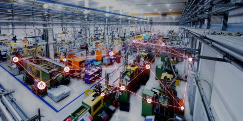a photo of a manufacturing facility, with a digital network grid overlayed.