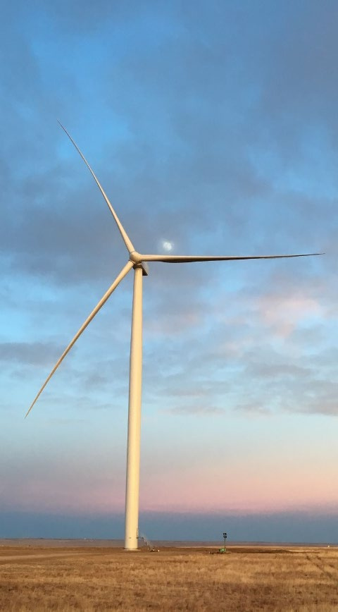 Wind turbine against a sunset.