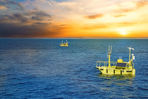 Photo of two buoys in the water with a graphic overlay to indicate data flowing into the buoy and number of registered users (1,060) and registered projects (20).