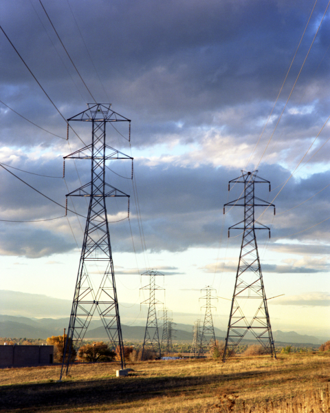 Power lines in front of a sunset.