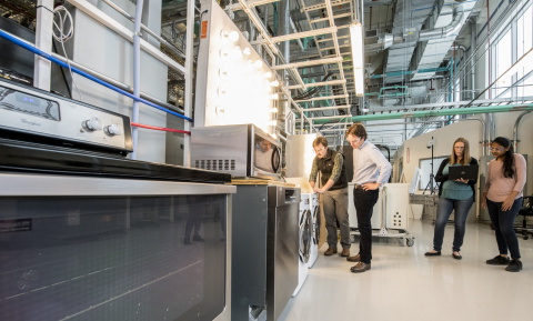 Workers in the NREL Energy Systems Integration Facility