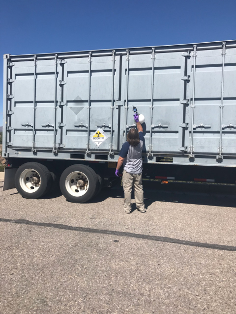 A worker with Newport News Nuclear BWXT-Los Alamos, the cleanup contractor for the EM Los Alamos Field Office (EM-LA), surveys EM-LA's 30th transuranic waste shipment of fiscal 2021 in Area G at Technical Area 54 for on-site loading at the Radioassay and Nondestructive Testing facility at Los Alamos National Laboratory.